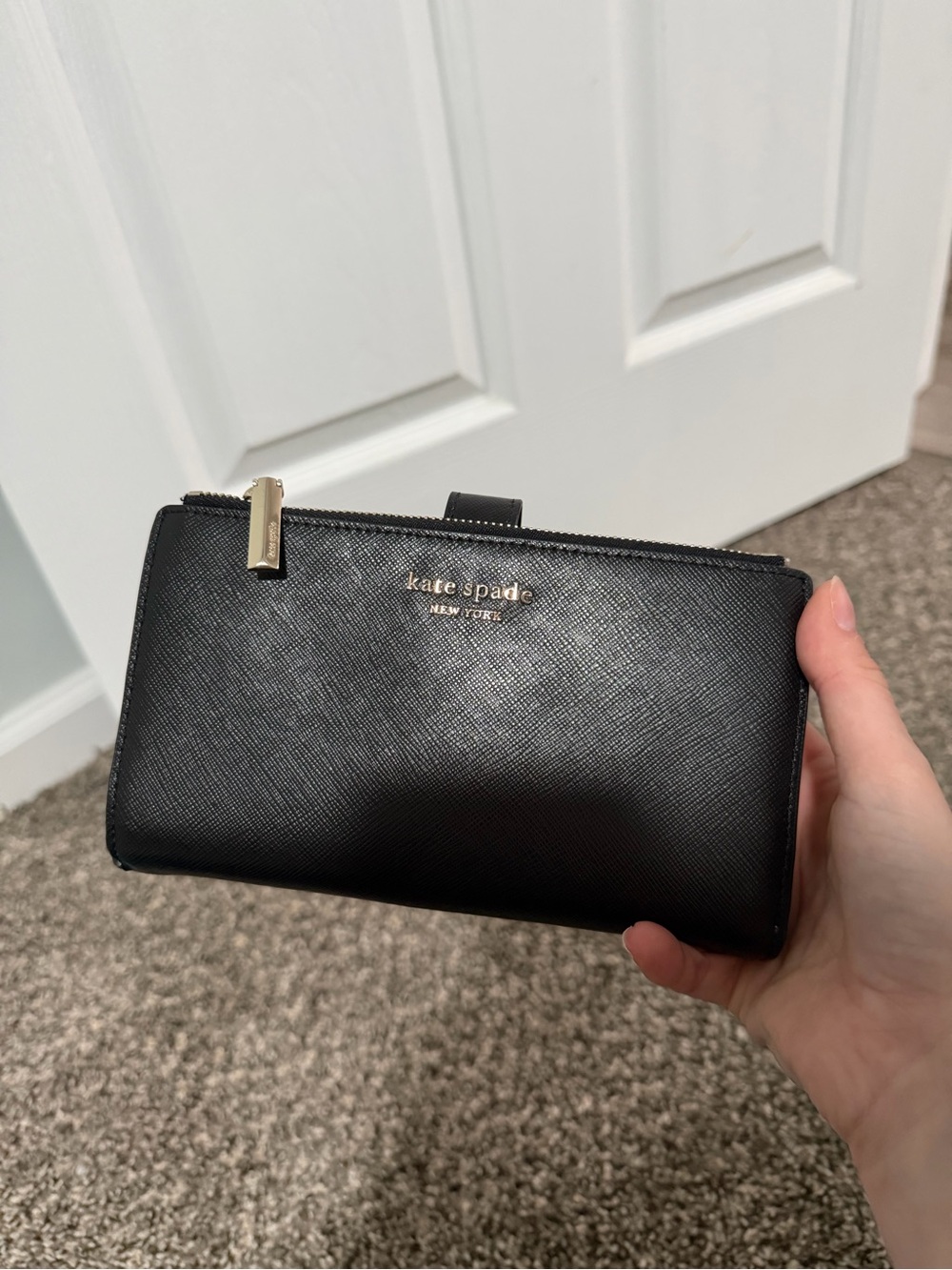 kate spade black saffiano zip-around wallet with gold logo